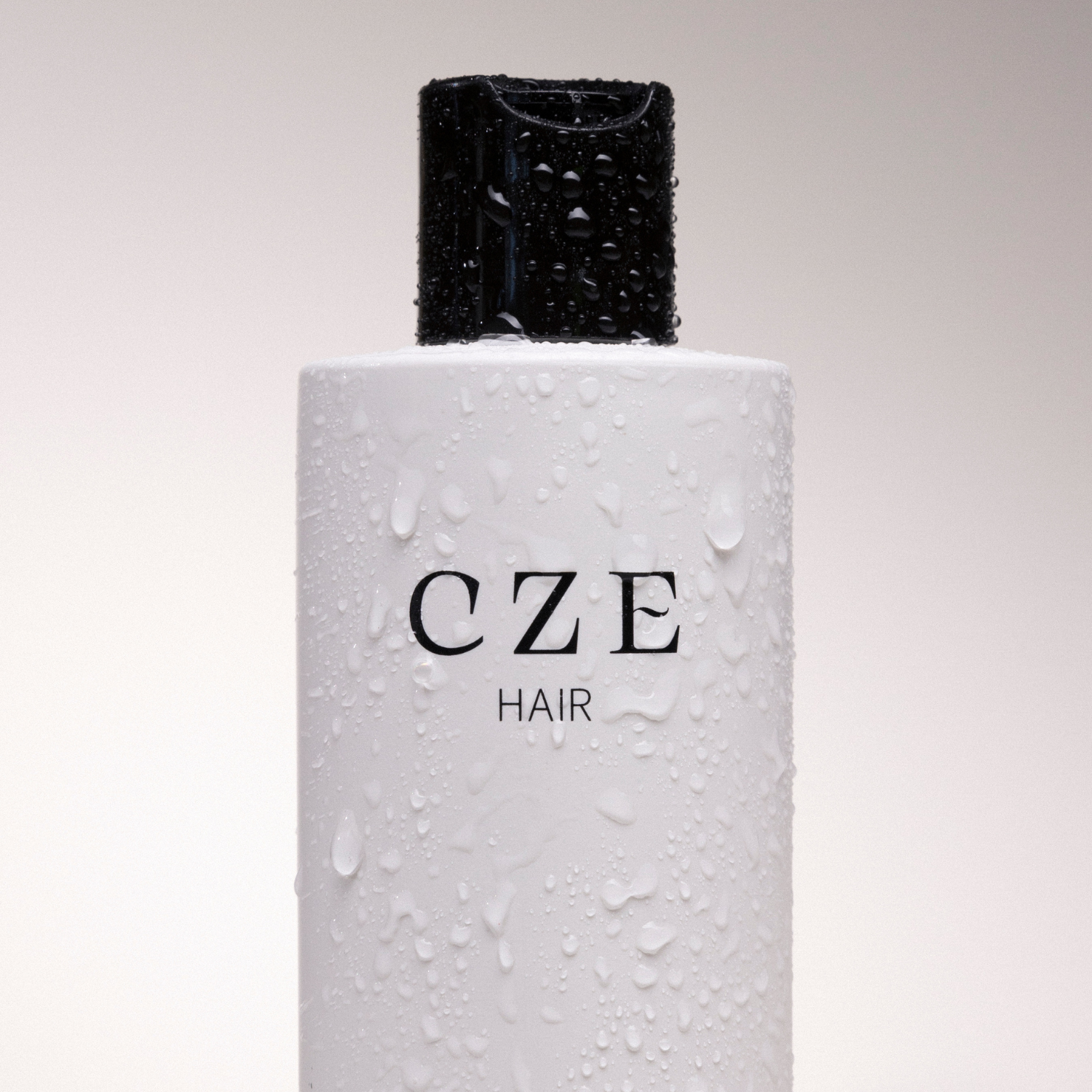 CZE Hair Silk Wash bottle with water droplets – clean, hydrating shampoo