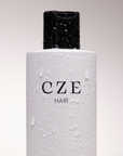CZE Hair Silk Wash bottle with water droplets – clean, hydrating shampoo