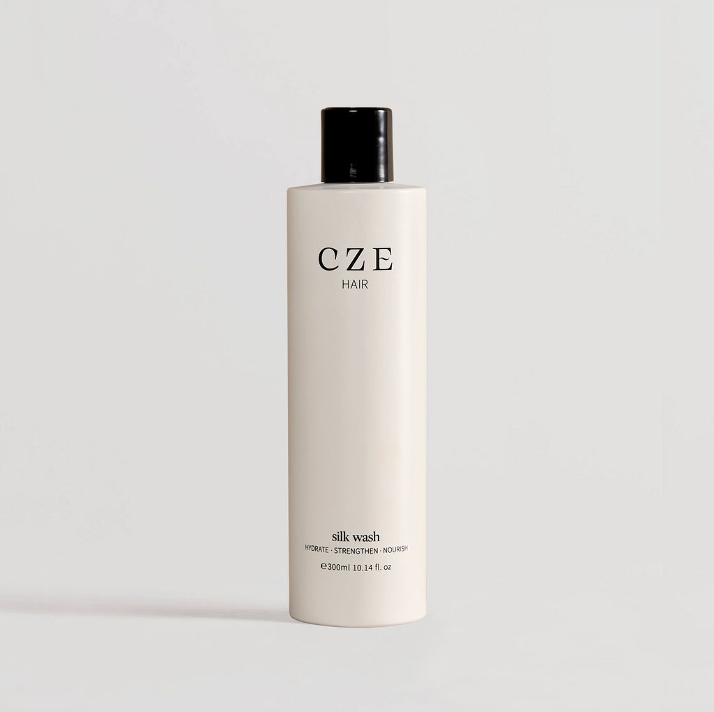 White 300ml bottle of CZE Hair Silk Wash shampoo – hydrates, strengthens, and nourishes hair

