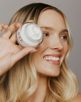 Model holding CZE Hair curl defining cream – lightweight and anti-frizz styling solution.